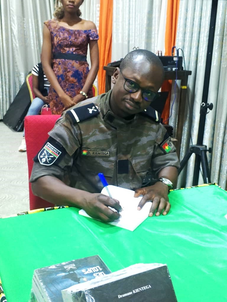 L’auteur dédicaçant une œuvre